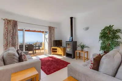 a living room with two couches and a television at The View – Santo António Villas, Golf & Spa in Salema