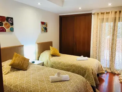 two beds in a hotel room with towels on them at Rother Praia da Luz Luxury Apartment in Luz