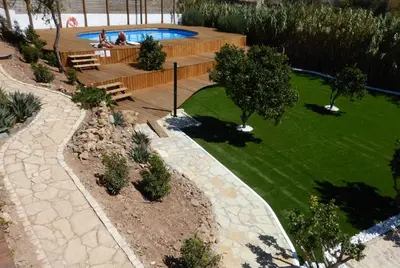 an overhead view of a garden with a swimming pool at Good Feeling Hostel & Guest House in Raposeira