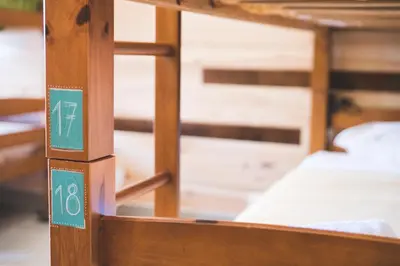 a close up of a wooden bunk bed at Good Feeling Hostel & Guest House in Raposeira