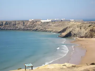 a hotel room with two beds and a desk at Aparthotel Navigator in Sagres