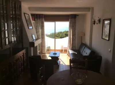 a living room with a couch and a table at Apartamentos Salema Praia Club in Salema