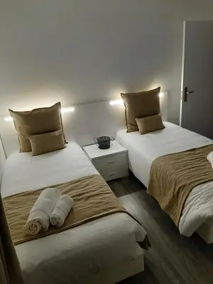 two beds sitting next to each other in a room at Grannies House in Machico