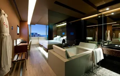 a building with a reflection of a city in the water at The Vine Hotel in Funchal