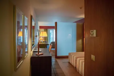 a living room with a bed and a table in a room at Apartamentos Turisticos Atlantida in Funchal