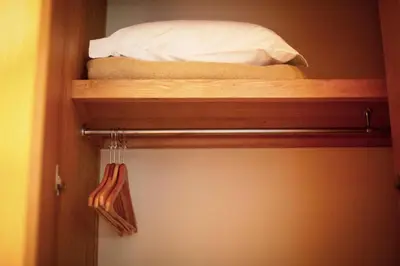 a bed on a wooden shelf in a room at Apartamentos Turisticos Atlantida in Funchal