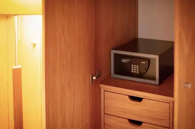 a small microwave sitting on top of a wooden cabinet at Apartamentos Turisticos Atlantida in Funchal