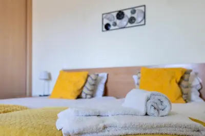 a bedroom with two towels on a bed at Montinhos Nature Stay in Luz