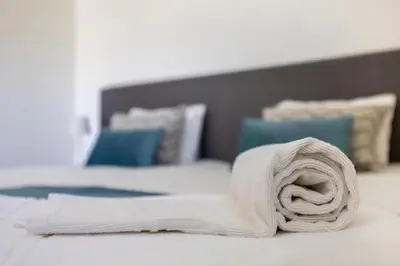 a rolled up towel on top of a bed at Montinhos Nature Stay in Luz