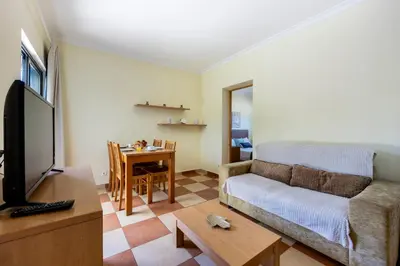 a living room with a couch and a table at Montinhos Nature Stay in Luz