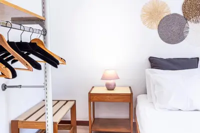 a bedroom with a bed and a shelf with shoes at Casa da Ribeira in Funchal