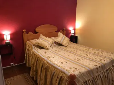 a bedroom with a bed with two pillows on it at Casa da Igreja in Santana