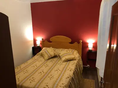 a bedroom with a bed with two pillows on it at Casa da Igreja in Santana