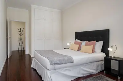 a bedroom with a large white bed with pillows at Golden Star AV by An Island Apart in Funchal