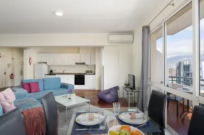a living room with a couch and a table at Golden Star AV by An Island Apart in Funchal