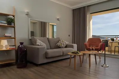 a living room with a couch and a table at Madeira Panorâmico Hotel in Funchal