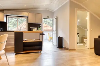 a kitchen and dining room with a table and chairs at Casa da Praia, a Home in Madeira in Tábua