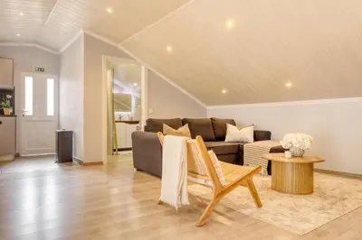 a living room with a couch and a kitchen at Casa da Praia, a Home in Madeira in Tábua