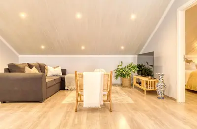 a living room with a couch and a table at Casa da Praia, a Home in Madeira in Tábua