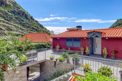 a house with a balcony with a mountain at Casa da Praia, a Home in Madeira in Tábua