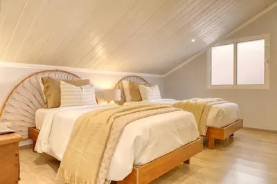 a bedroom with two beds and a window at Casa da Praia, a Home in Madeira in Tábua