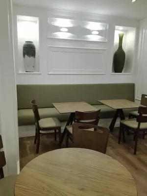 a restaurant with tables and chairs and vases on the wall at Hotel Do Centro in Funchal