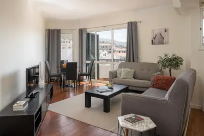 a living room with a couch and a tv at Golden Star AU by An Island Apart in Funchal