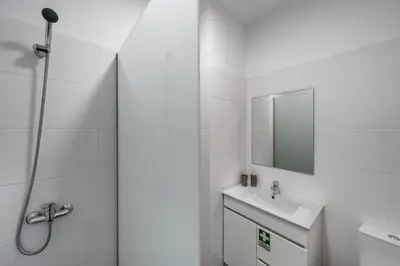a white bathroom with a sink and a shower at Golden Star AU by An Island Apart in Funchal