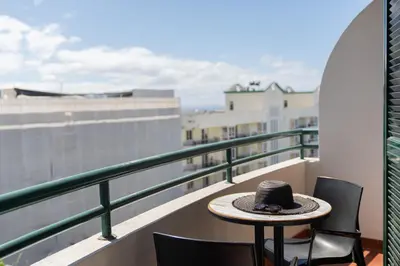 a hat sitting on a table on a balcony at Golden Star AU by An Island Apart in Funchal
