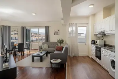 a kitchen and living room with a couch and a table at Golden Star AU by An Island Apart in Funchal