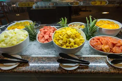 a buffet with bowls of different types of fruit at Vila Baleira Porto Santo in Porto Santo