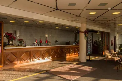 a lobby with a bar and chairs in a building at Ocean Gardens in Funchal