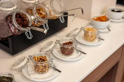 a buffet of food in glass jars on a counter at Belavista Da Luz - Wellness & Lifestyle Hotel in Luz