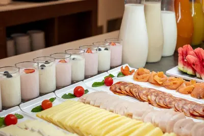 a table topped with cheese and meats and candles at Belavista Da Luz - Wellness & Lifestyle Hotel in Luz