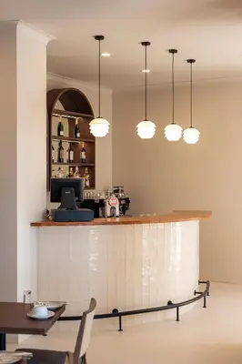 a restaurant with a bar with lights above it at Belavista Da Luz - Wellness & Lifestyle Hotel in Luz