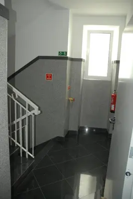 a hallway with a staircase with a window and a door at Flat view Mercado in Funchal