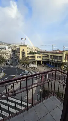 a view of a city with a rainbow in the distance at Flat view Mercado in Funchal