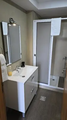 a bathroom with a white sink and a shower at Flat view Mercado in Funchal