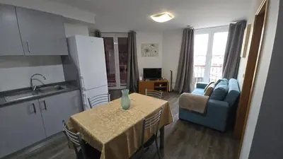 a kitchen and dining room with a table and a kitchen and a table and chairs at Flat view Mercado in Funchal