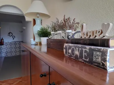 a desk with books and a lamp on top of it at Aurora Sol in Luz