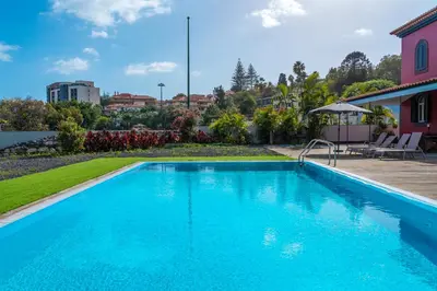 a swimming pool in the backyard of a house at Century House with private pool by Holiday Rental Madeira in Funchal