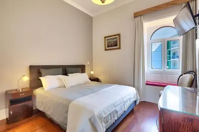 a bedroom with a large bed and a window at Century House with private pool by Holiday Rental Madeira in Funchal