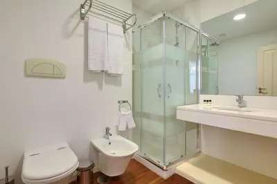 a bathroom with a shower and a toilet and a sink at Century House with private pool by Holiday Rental Madeira in Funchal