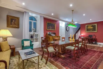 a living room with a table and chairs at Century House with private pool by Holiday Rental Madeira in Funchal