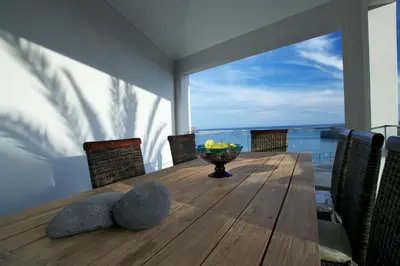 a dining room table with a view of the ocean at The Docks in Paul do Mar