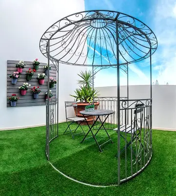 a metal gazebo with a table in a yard at Mareta Beach - Boutique Bed & Breakfast in Sagres