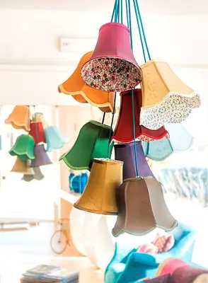a group of different colored bells hanging from a ceiling at Mareta Beach - Boutique Bed & Breakfast in Sagres