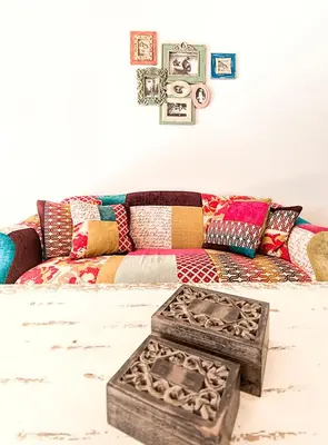 a living room with a couch with colorful pillows at Mareta Beach - Boutique Bed & Breakfast in Sagres