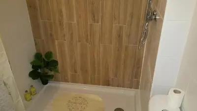 a small bathroom with a toilet and a shower at Sunset Relax Porch in Lagos