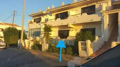 a view from a car of a building with a blue arrow at Sunset Relax Porch in Lagos